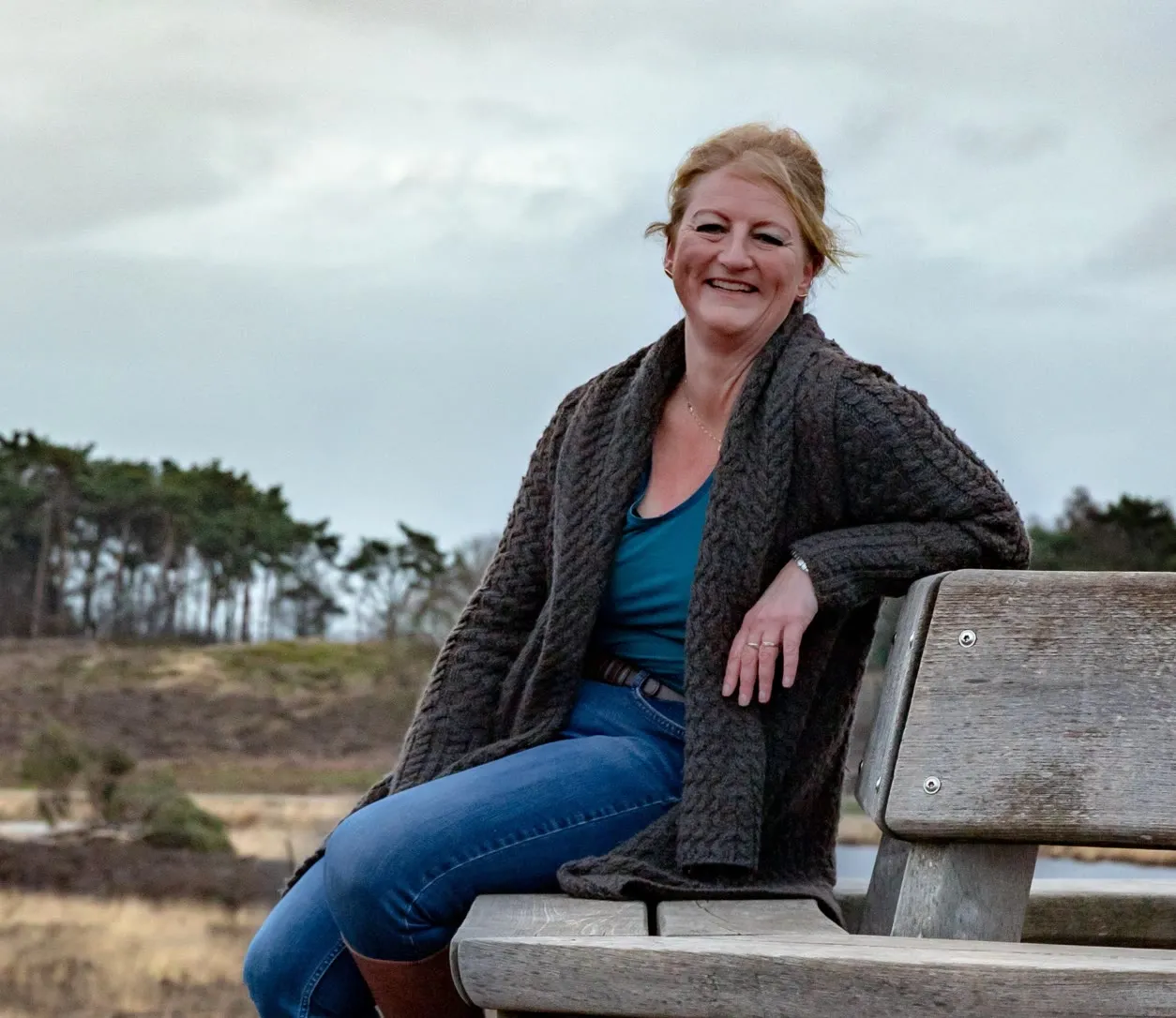 Marja Bouma buiten op een bankje op de heide